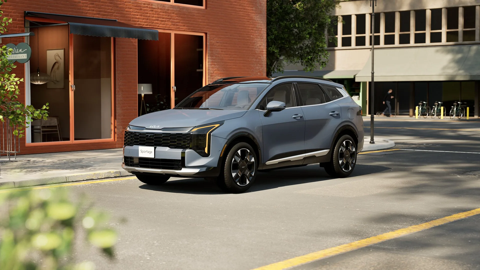 Kia Sportage hybride 2026 gris stationné dans une rue devant un immeuble de brique